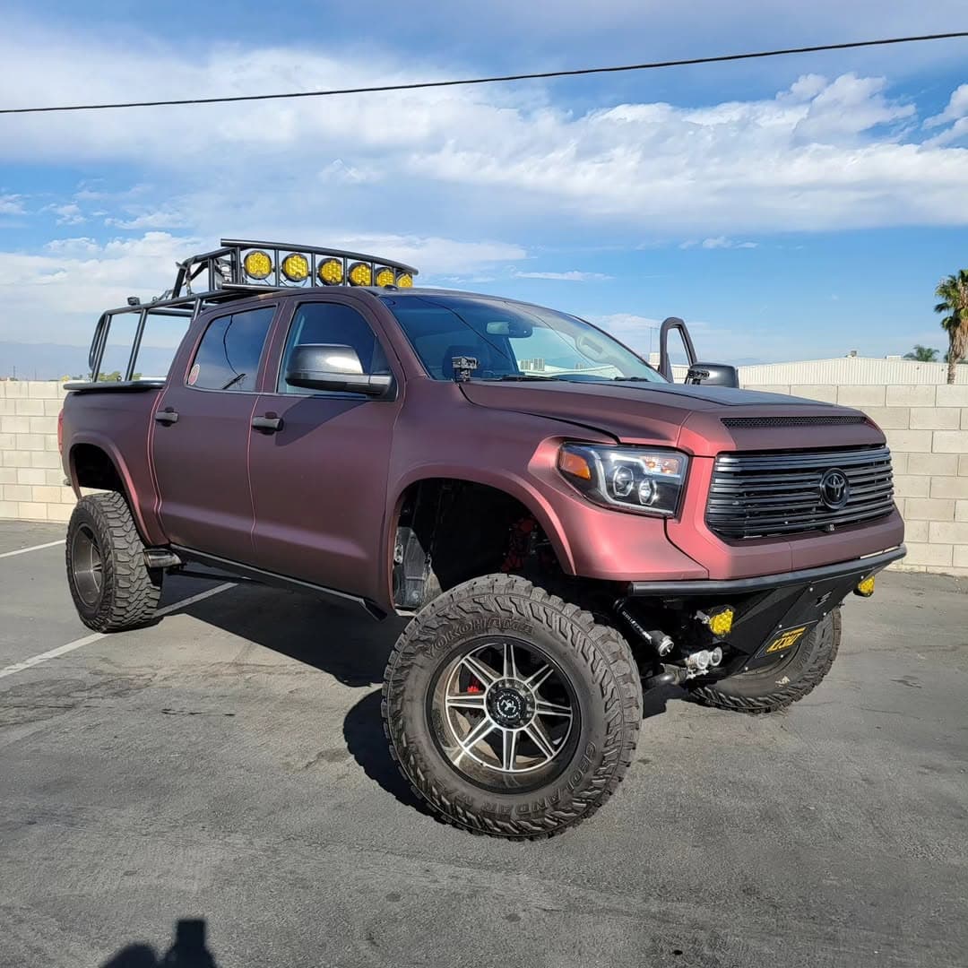 Lifted Toyota Tundra with matte burgundy color change wrap